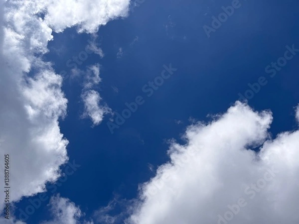 Fototapeta Beautiful blue sky with white clouds. The sky was clear and bright, and clouds were scattered all over the sky. The scene was peaceful and serene, as if the viewer was gazing at a beautiful day.