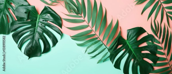 Obraz Tropical green leaves arranged on pastel pink and mint background for summer design concept