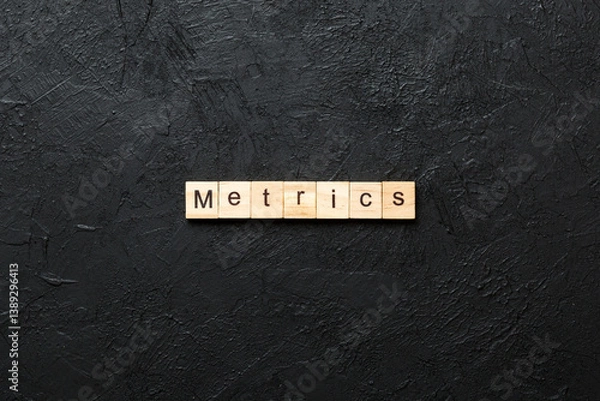 Fototapeta METRICS word written on wood block. METRICS text on cement table for your desing, concept