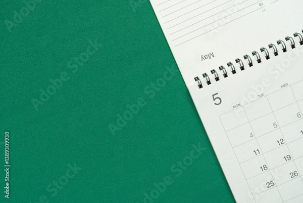Fototapeta close up of calendar on the green table background, planning for business meeting or travel planning concept
