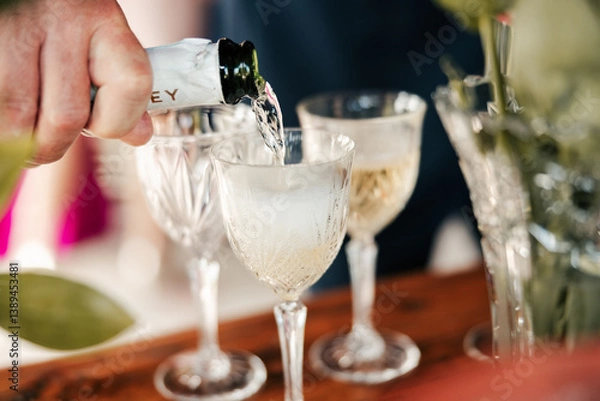 Fototapeta A moment of celebration, a glass in hand, and a toast to love, laughter, and the memories yet to be made. A sip of joy to mark the beginning of forever.
