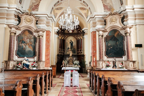 Fototapeta Gracefully adorned with ribbons and blooms, the church whispers elegance. Each detail adds a touch of romance to the sacred space where vows will soon be exchanged.