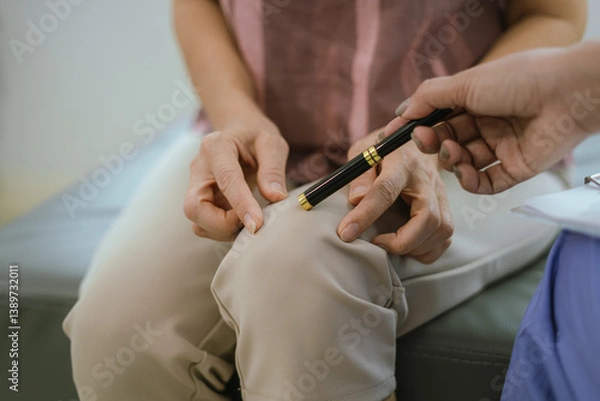 Fototapeta A female doctor examines an elderly patient with knee pain due to arthritis. The patient is being assisted in recovery, focusing on pain management and improving mobility.