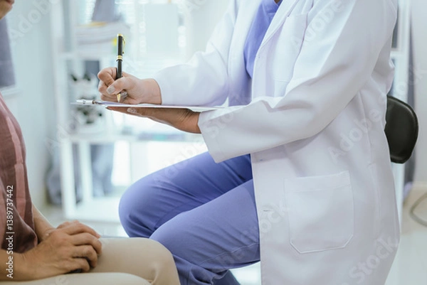 Fototapeta Doctor analyzes patient's blood test results and medication use on health screening concept chart.