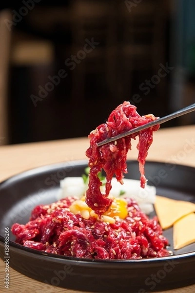 Obraz raw beef with chopsticks