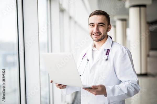 Obraz attractive young medical worker using laptop