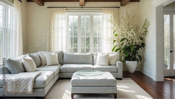 Obraz An open, airy living room with light gray furniture, a large plant, and lots of natural light