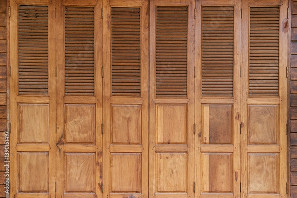 Fototapeta Wooden shuttered doors design rustic home exterior photography natural light close-up view architectural concept