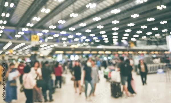 Fototapeta Defocus Blurry passengers people of crowd anonymous walking at the airport. scene of airport with passengers activity. Terminal Departure Check-in at airport. Travel International concept.