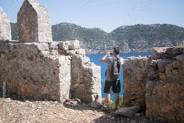 Obraz Tourist with backpack photographing Simena bay