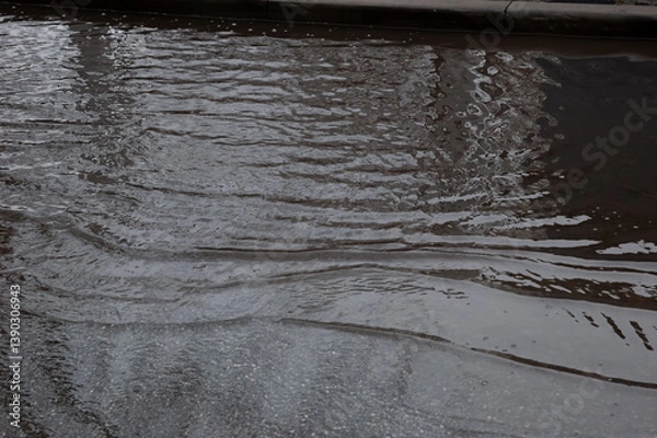 Fototapeta the waves run in a deep, dark puddle.