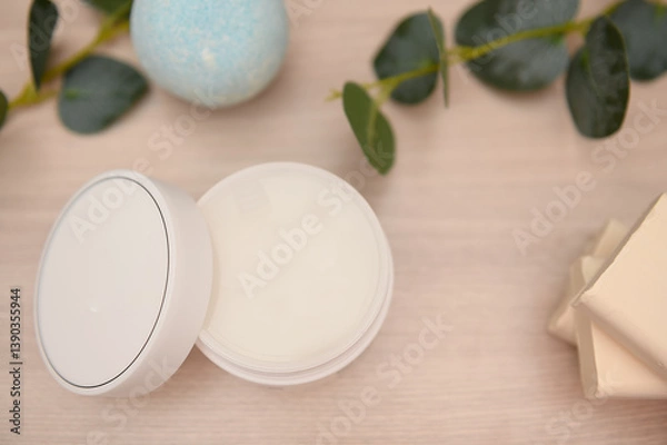 Obraz Cosmetic cream, bath salt on a wooden table, white soap, eucalyptus branches.