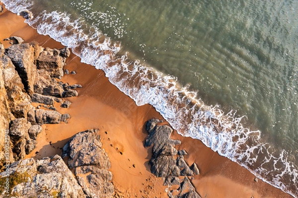 Fototapeta Beautiful ocean landscape from a drone. View of the ocean, rocks and sand.