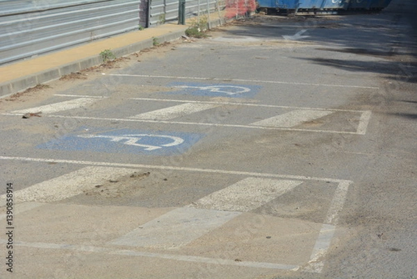 Fototapeta Parking area showing faded markings and debris near construction site on a sunny day