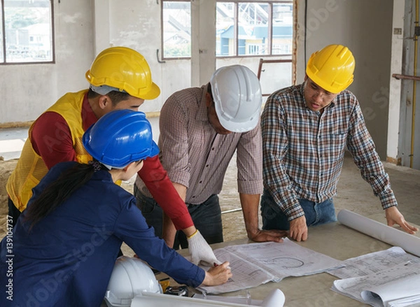 Fototapeta business people group on meeting and presentation with construction engineer architect looking building model and blueprint plans