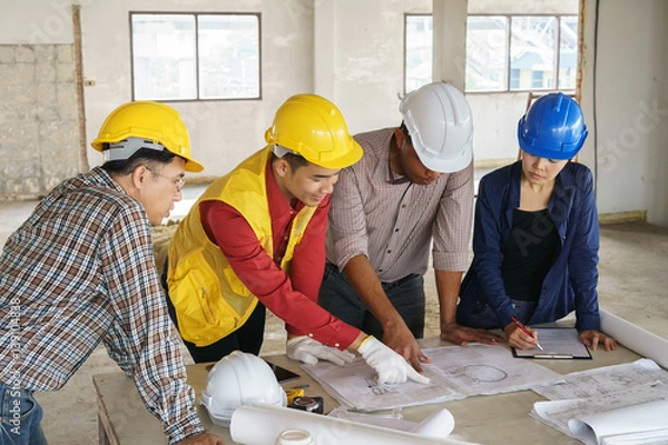 Fototapeta business people group on meeting and presentation with construction engineer architect looking building model and blueprint plans