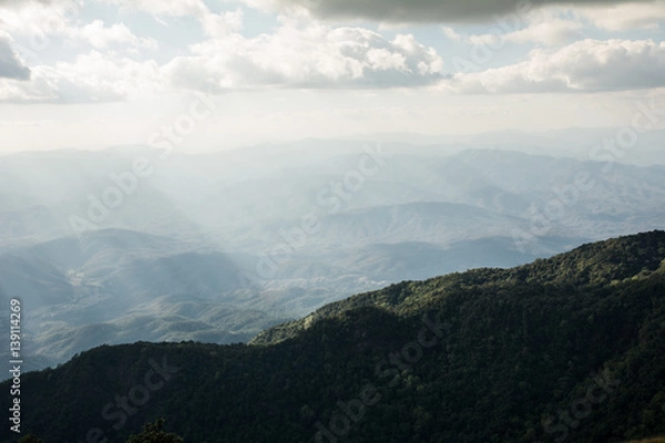 Fototapeta Beautiful sun rays through the clouds over mountains,evening light,Amazing scene