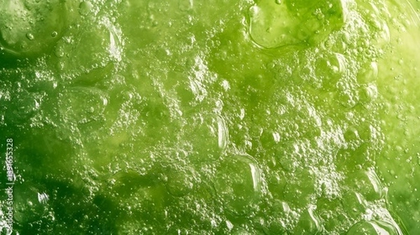 Fototapeta Close-up of a green, viscous, textured substance with air bubbles.