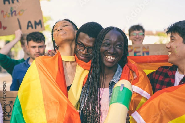 Fototapeta Happy multiethnic activists embracing with a rainbow flag at lgbtq pride parade