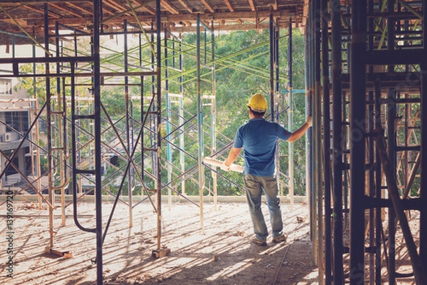 Fototapeta Construction concepts, Engineer and Architect working at Construction Site with blueprint, Vintage Effect