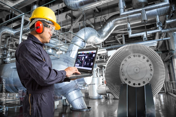 Fototapeta Engineer using laptop computer in thermal power plant factory