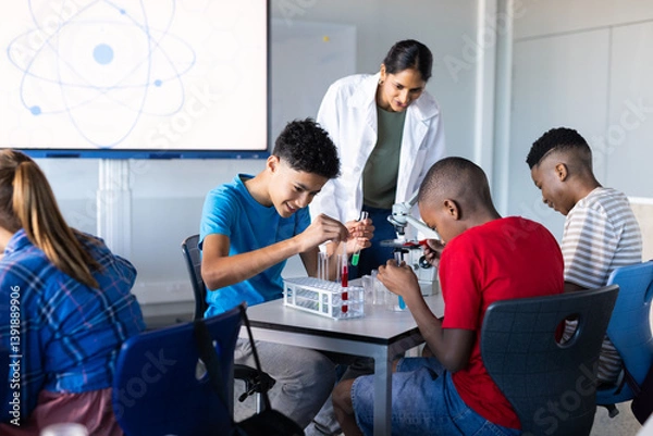 Fototapeta In school, students conducting science experiments with test tubes and microscope