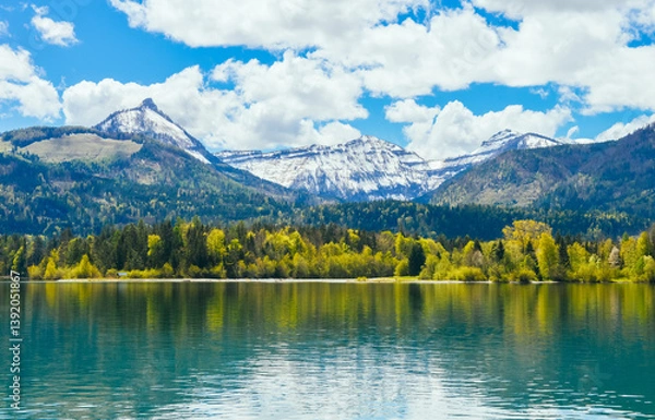 Fototapeta Beautiful landscape of snow mountain and grassland scenery in St. Wolfgang, Salzburg,  Austria, shot in early May