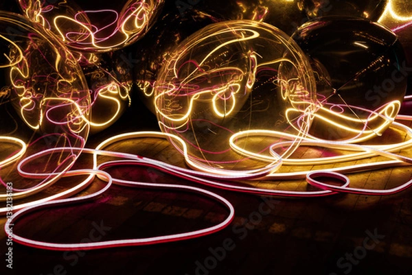 Fototapeta A bunch of glowing balls are arranged in a line. The balls are neon
