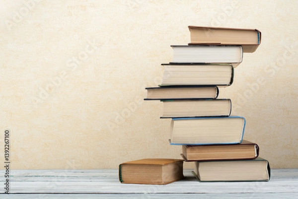Obraz Stack of colorful books. Education background. Back to school. Book, hardback colorful books on wooden table. Education business concept. Copy space for text.