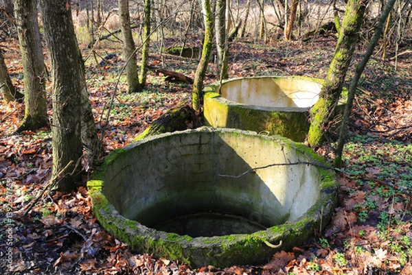 Obraz abandoned concrette wells in forest