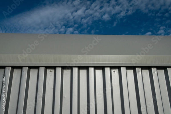 Fototapeta Steel corrugated sheet for facades is an insulating and resistant material, often used for its ability to offer excellent protection and insulation. Ideal modules in the architecture of a building