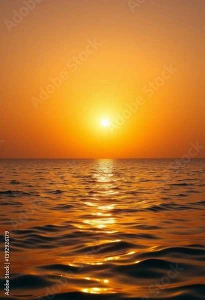 Fototapeta   a beautiful sunset over the ocean, with the sun setting in the sky and reflecting off the water's surface