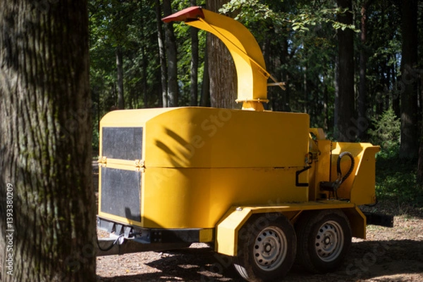 Fototapeta Wood processing machine. Diesel powered stick cutting equipment.