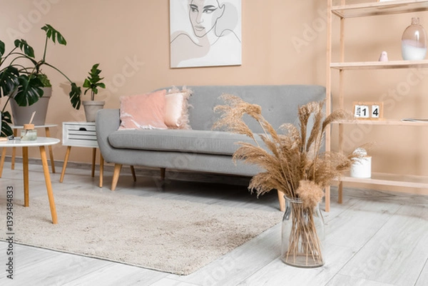Fototapeta Stylish living room with comfortable sofa, coffee table and shelving unit