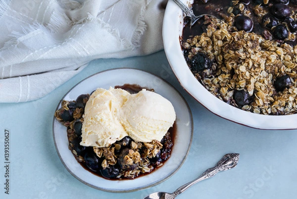 Fototapeta Homemade cherry crisp served with French vanilla ice cream. Table top view. Flatlay.