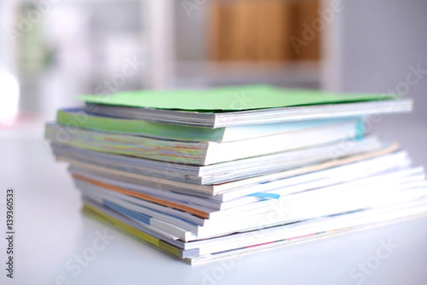 Fototapeta close up of stack of papers on white background