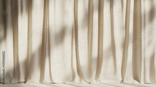 Fototapeta Soft beige fabric curtains gently swaying, casting intricate shadows on a bright, sunny surface, creating a serene and calming atmosphere