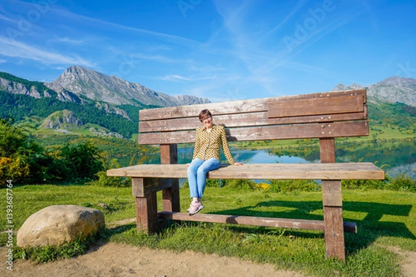 Fototapeta Woman on top of the highest bench in the León communi