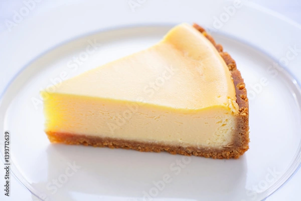 Obraz Simple Cheesecake Slice with Graham Crust on White Surface