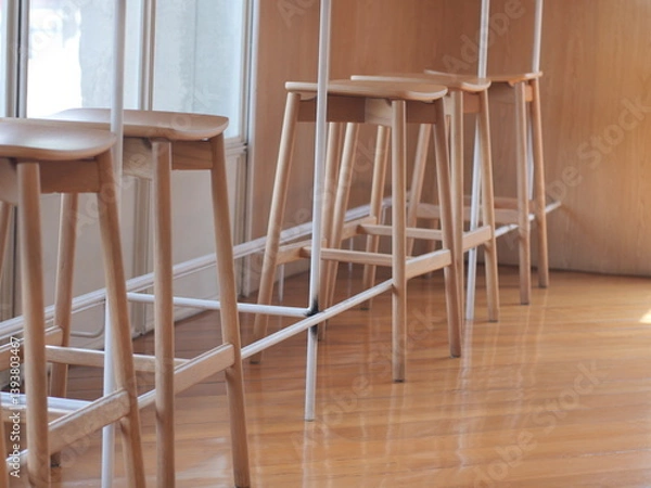 Fototapeta wooden chair on the table. Set High of wooden chair at the counter bar. Famous interior design in coffee shop.