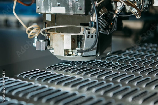 Fototapeta close up of cnc punching press machine with metal plate