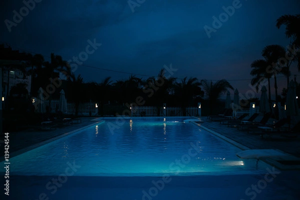 Fototapeta Swimming pool in night illumination tropical island