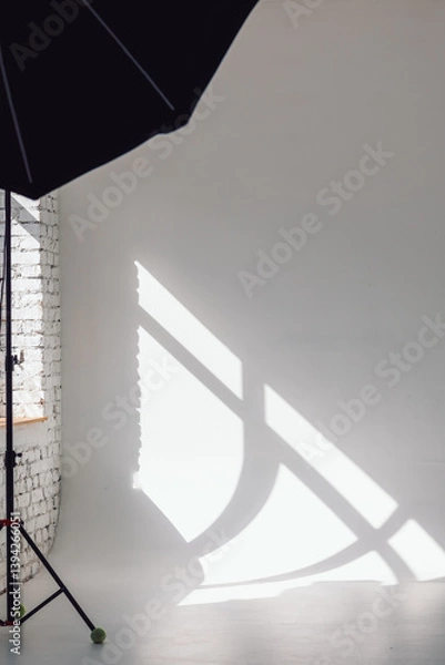 Obraz Clear white cyclorama. Light background with with professional lighting equipment. Plain wall empty photo studio. Vertical photo.