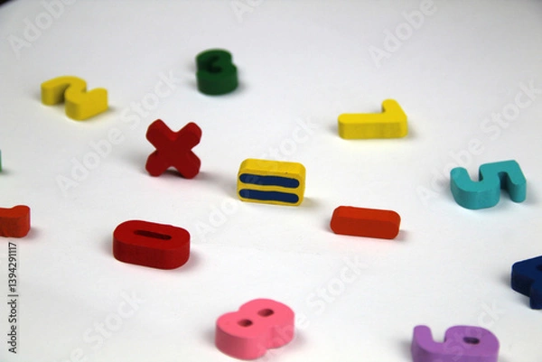 Fototapeta On a white background there are mathematical signs, in a crumpled shape of numbers. The concept of education and school.