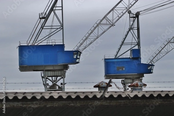 Fototapeta Cranes of a shipyard in the coastal town Haugesund, Norway, on the island Risoy. Scandinavia, Europe.