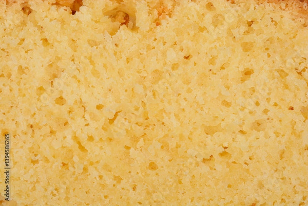 Obraz A detailed close-up shows the porous texture of a slice of yellow lemon cake