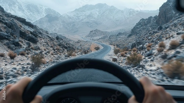 Obraz A driver s perspective of a winding road through a rugged desert landscape  long title A first person view from the driver s seat as the vehicle