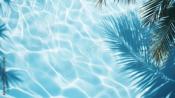 Fototapeta Tranquil turquoise swimming pool water with rippling surface and soft palm tree shadows creating a serene tropical summer relaxation scene