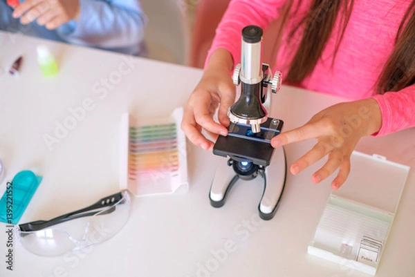 Obraz Close-up of a microscope and glass with sample cells for examination.