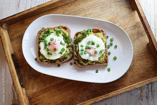 Fototapeta Toast with boiled egg and pesto sauce on rustic background. Top view.